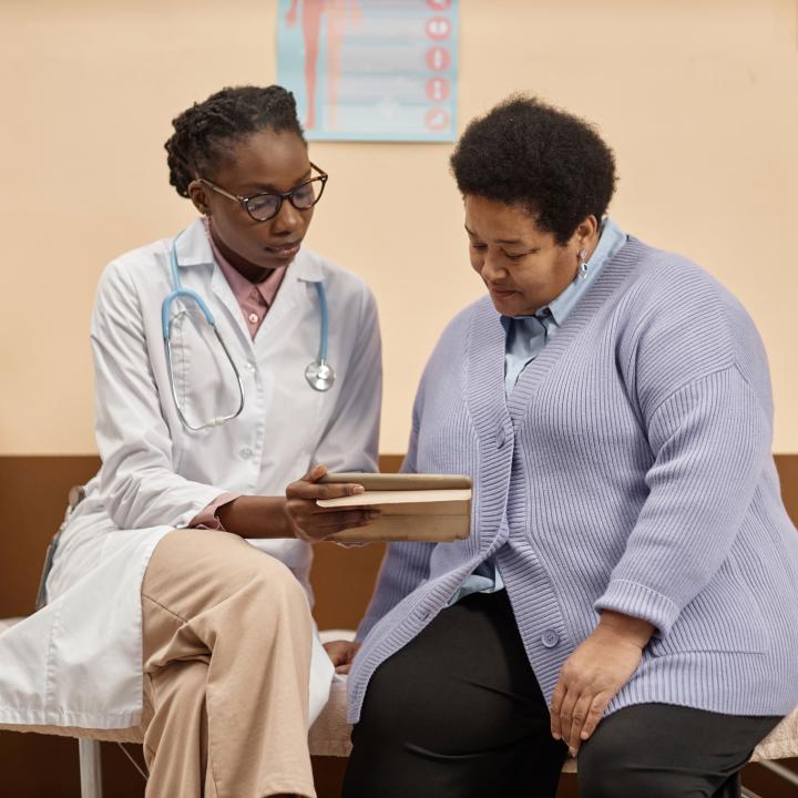 A doctor speaks with an overweight patient