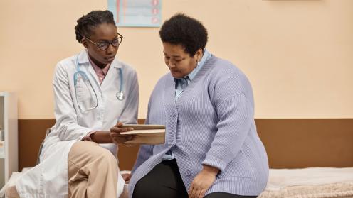 A doctor speaks with an overweight patient
