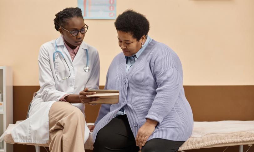 A doctor speaks with an overweight patient