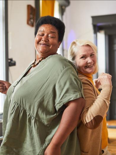 Two women dancing back to back