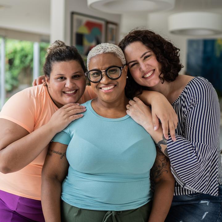 Three overweight female friends showing each other support