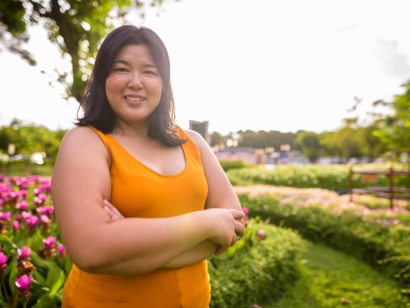 Beautiful overweight Asian woman with arms crossed