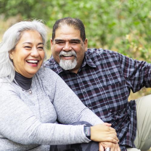 Smiling heavyset senior Hispanic couple