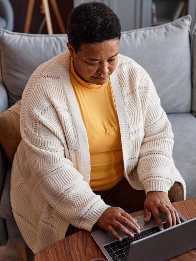 Senior African American obese woman at laptop computer